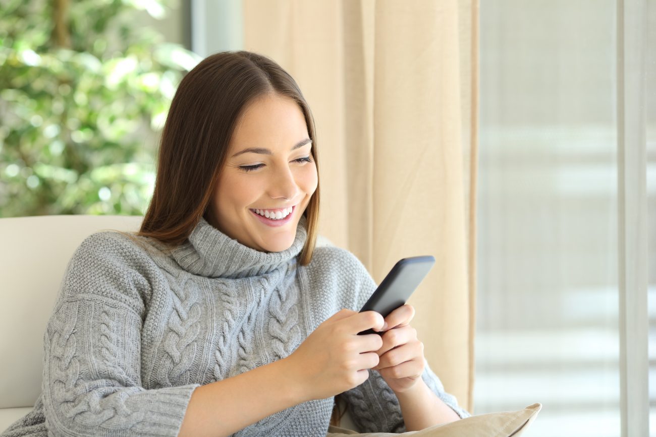 The owner of a smart home using her phone