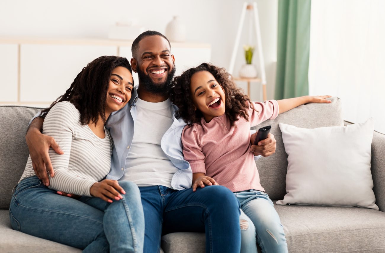 Happy family in a home on a couch